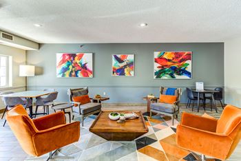 a living room with couches and chairs and a table